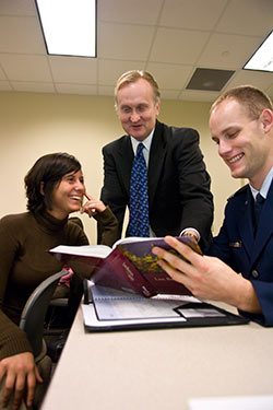 photo of two students and a professor in class