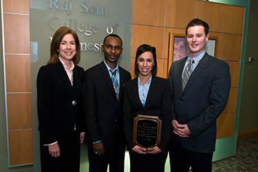 photo of students and an instructor with an award
