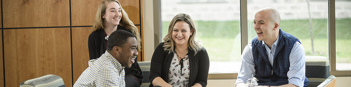 Wright State students sit and study having a good time with icons of Wright State various accreditations including best online graduate business degrees, AACSB, ABET, and the princeton review