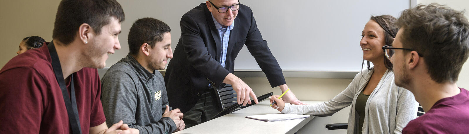 photo of students and a professor in a classroom