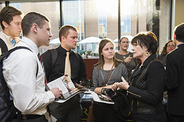 photo of students talking to a board member